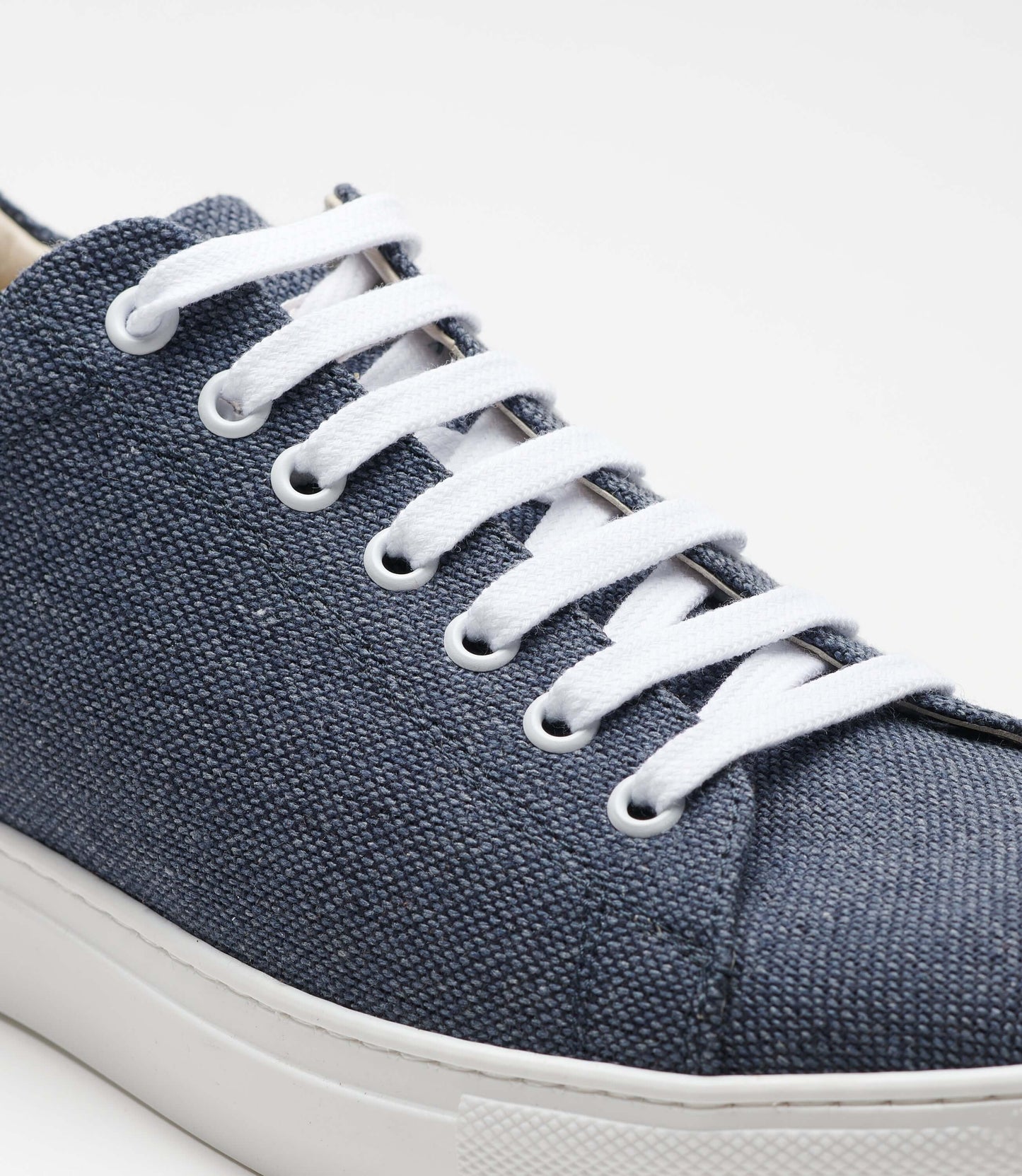 Close-up of the Vegan Hemp Sneaker V1 showcasing its blue hemp fabric and white laces.